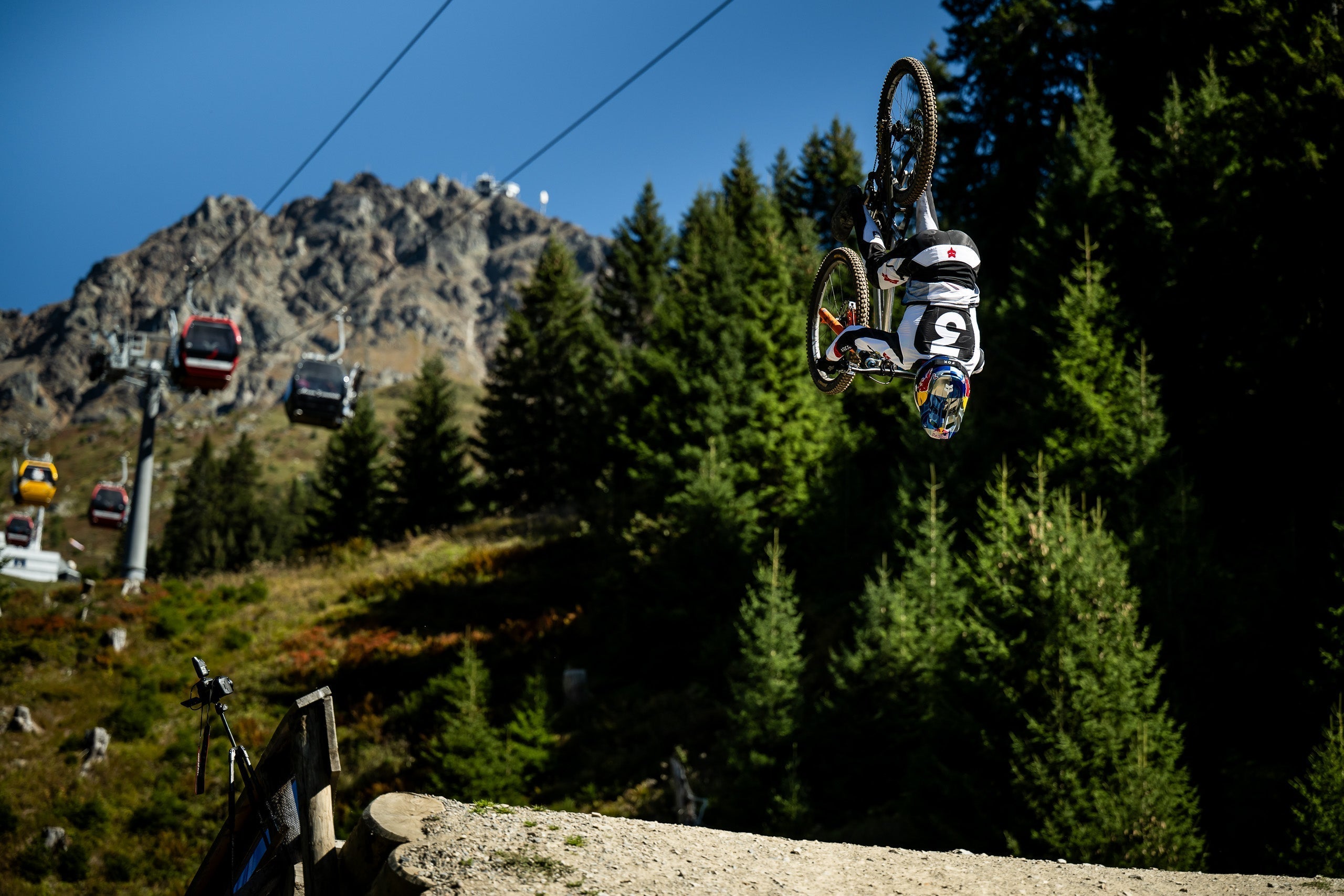 Mountainbiker making a backflip over a kicker in lenzerheide