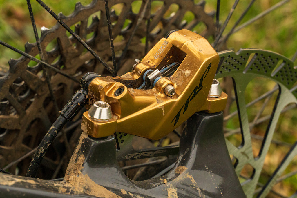 Close up of TRP EVO in gold mounted on Mountain bike