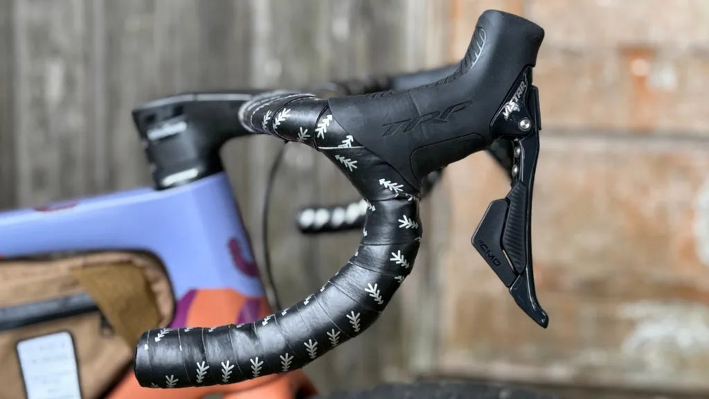 Close-up of a bicycle handlebar with VISTAR system handles on a blurred background